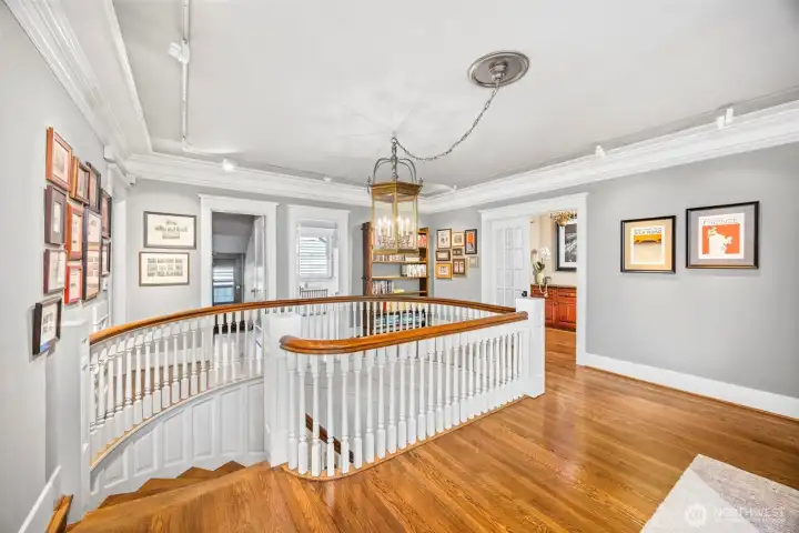 The grand upper landing flows effortlessly between private wings, steeped in character and light.