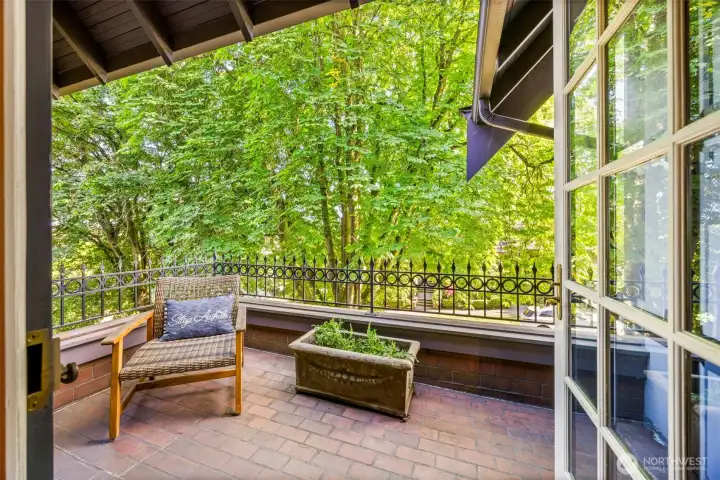Step onto the private veranda to enjoy a secluded, tree-lined escape suspended above the grounds.