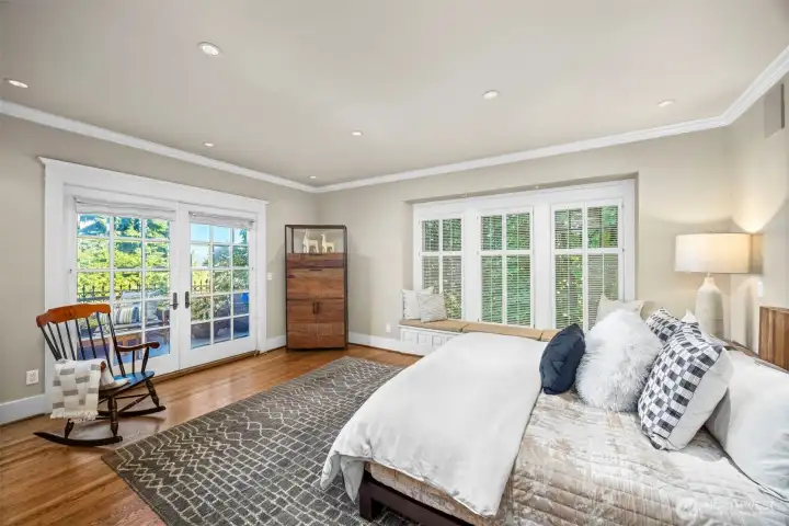 The expansive primary suite serves as a serene sanctuary, complete with a sunlit window seat and terrace access.