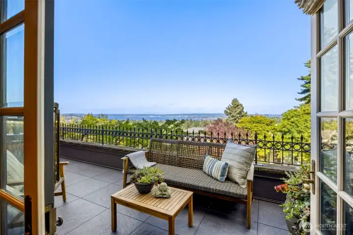 French doors open to a spectacular viewing deck where the beauty of Lake Washington unfolds before you.