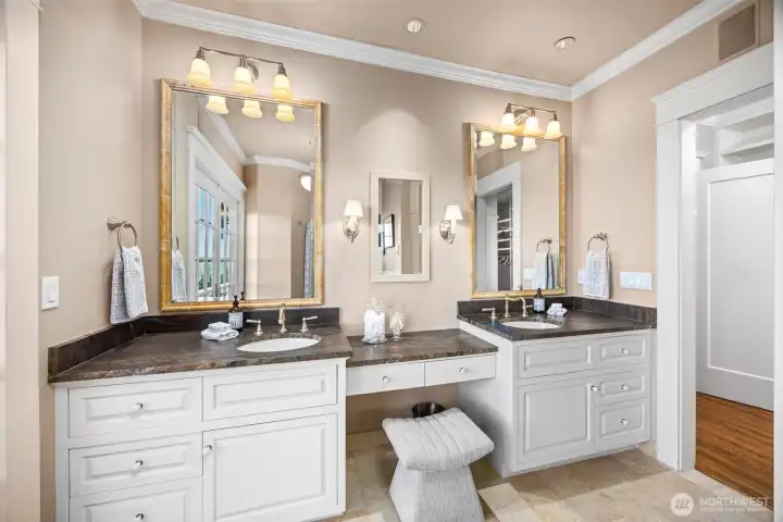The primary bathroom features dual vanities wrapped in elegant neutral tones.