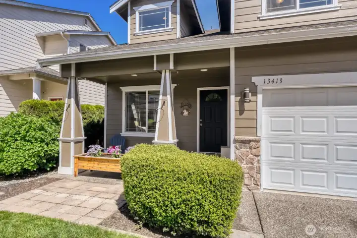ATTRACTIVE FRONT PORCH IS PERFECT FOR FURNITURE AND FLOWERS.