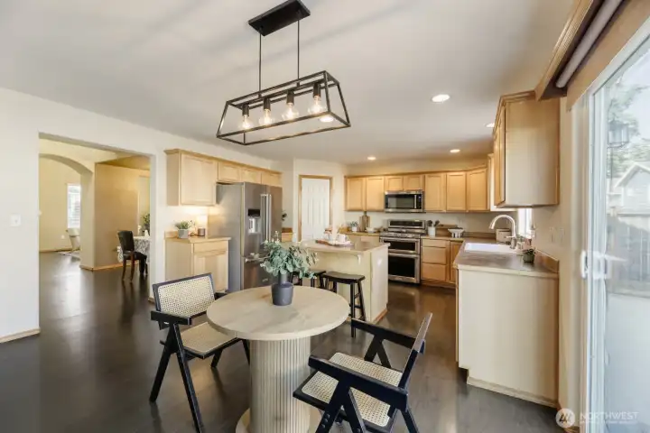 ATTRACTIVE KITCHEN WITH COMFORTABLE DINNING AREA.