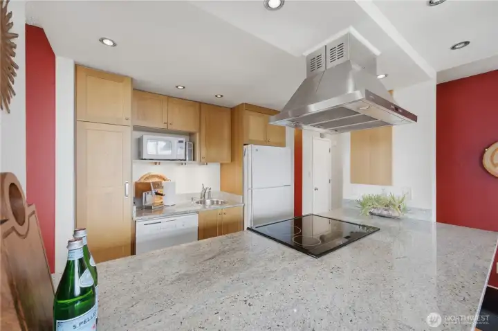 Check out the stunning slab granite countertops in this redesigned kitchen.