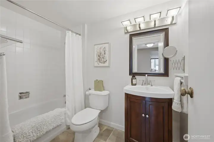 Lovely, updated bath with tile bath surround, gorgeous floors & a nice size vanity.