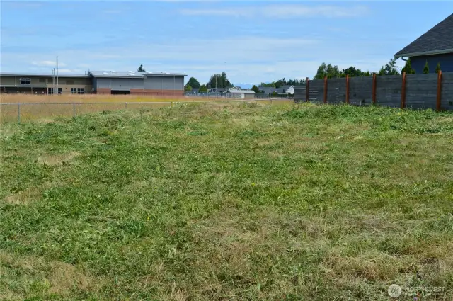 Mostly flat building lot that back up to a pasture and Lynden Middle School
