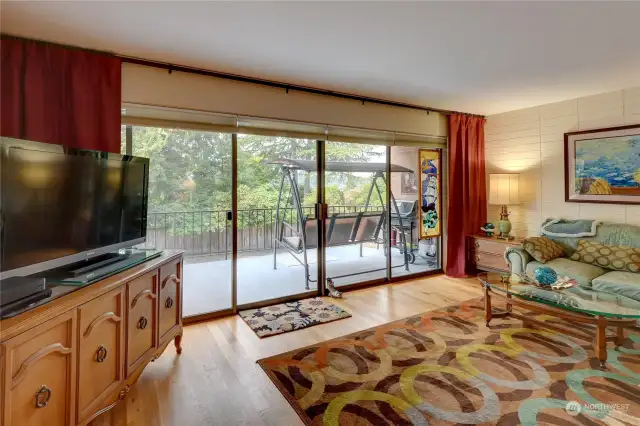 Living Room has Gleaming Hardwood Floors. Electric Power Drapes for Your Convenience