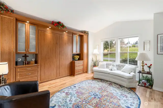 This home allows the use of this room as another sitting room or crafting room. A custom built in Murphy bed allows space saved then used for guests if needed. The view here is the common are across the street which has summertime community wine tastings.