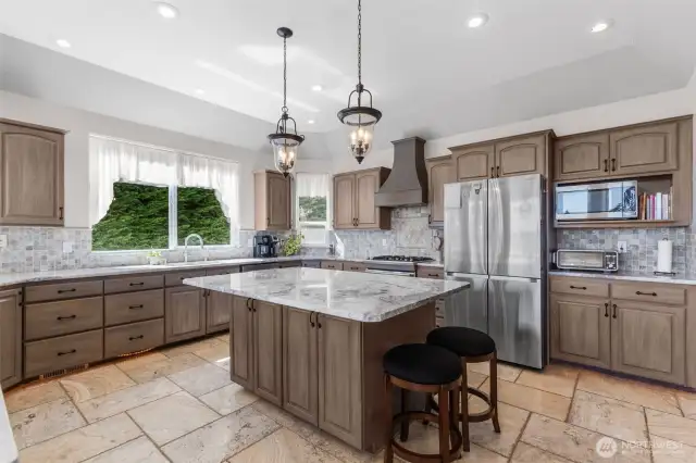 Gorgous gourmet kitchen with Island & bar. All appliances stay.