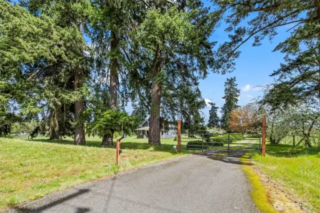 Gated entry on the right side of the wrap around driveway