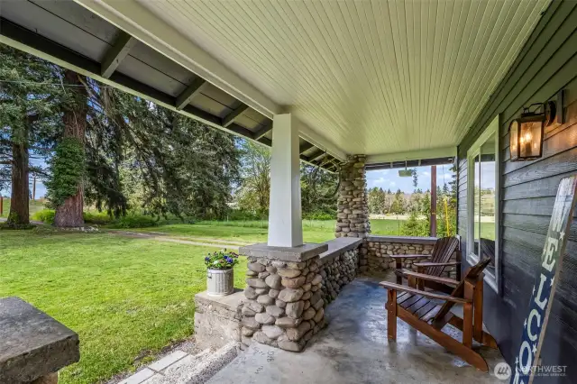 The cutest front porch overlooking the beautiful property