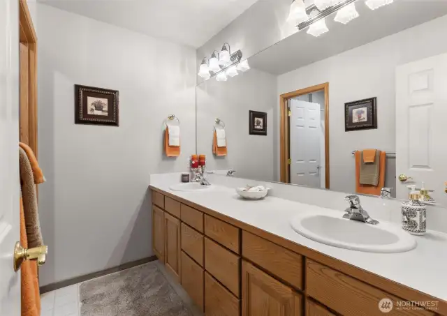 Full upstairs guest bathroom with separate shower and toilet room.