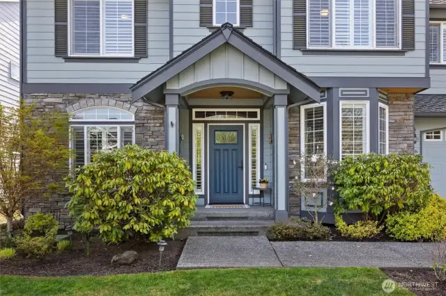 Welcoming covered front porch with cedar wood soffit and upgraded Andersen door.