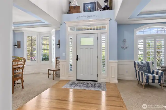 Light and bright entryway with refinished hardwood floors and updated chandelier.