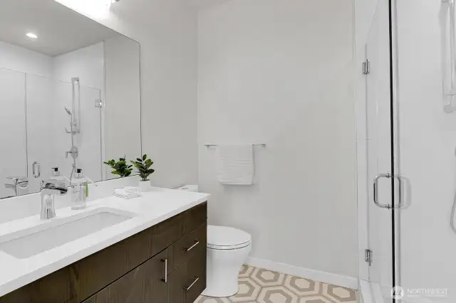 Huge shower in with designer tile flooring in Primary en-suite bathroom