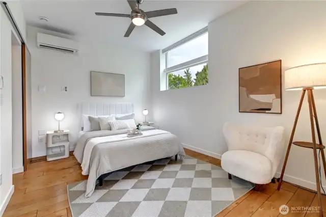 Beautiful upstairs primary suite featuring soaring ceilings, a mini-split A/C system and a private deck.