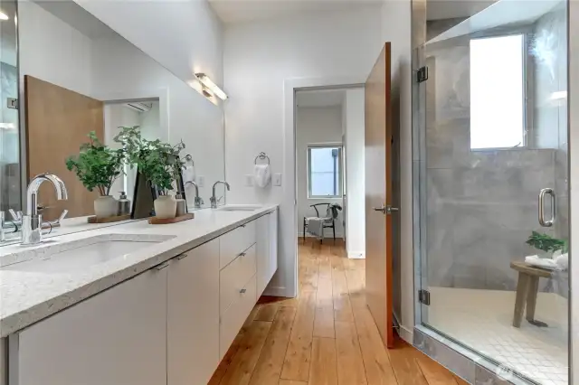 Spacious bathroom with dual sinks, and an oversized shower for a spa-like experience.