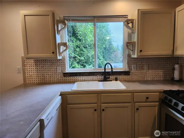 Note basket weave custom tile backsplash.