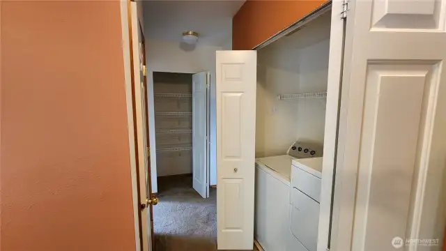 From the full bath, we go down the hallway, past the laundry area to another pantry/storage closet and 2 bedrooms.