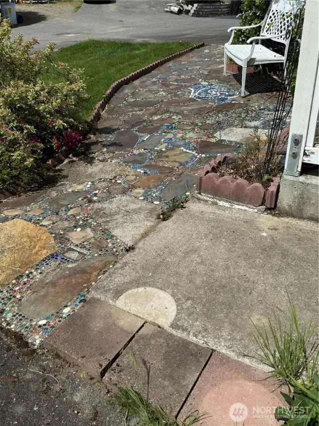 Owner and her grandchildren built this artistic path to the arbor. Please walk on stone steps. The glass beads can be slippery!