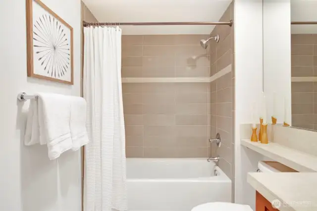 Function is elevated to indulgence in the bathroom, which features a deep soaking tub with accented tile surround.