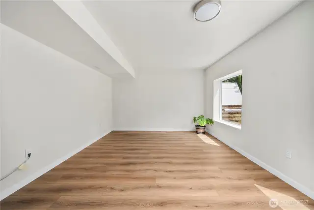Basement living space with new laminate vinyl plank flooring