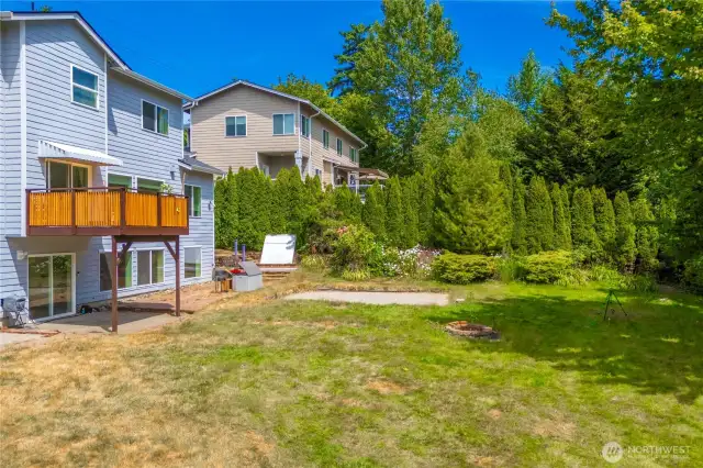 Large gently sloping backyard adjacent to green space providing privacy