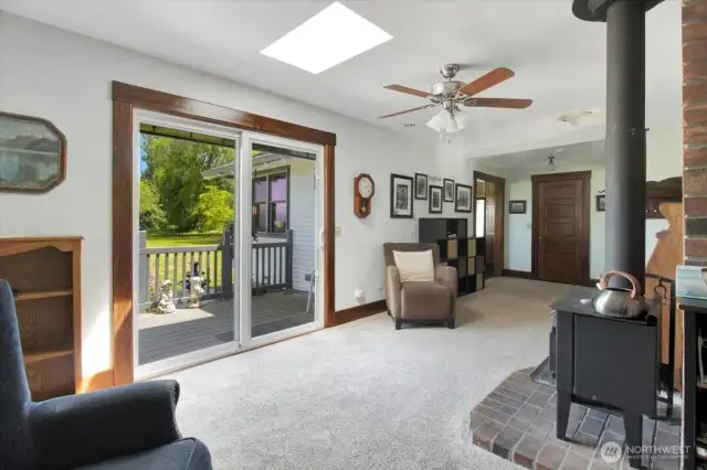 the cozy bonus room with slider to the deck and patio