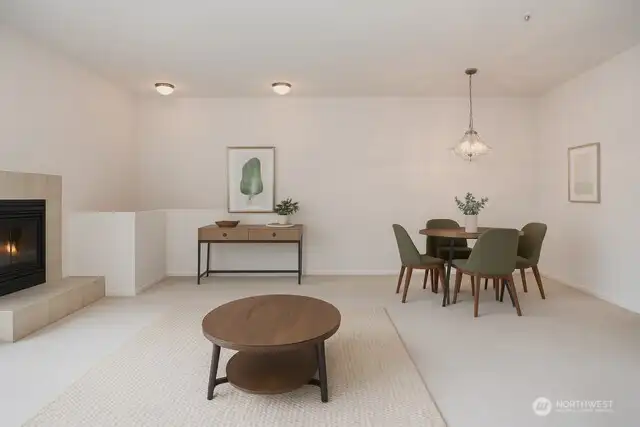 Living room with fireplace opens up to dining area. Virtually Staged.