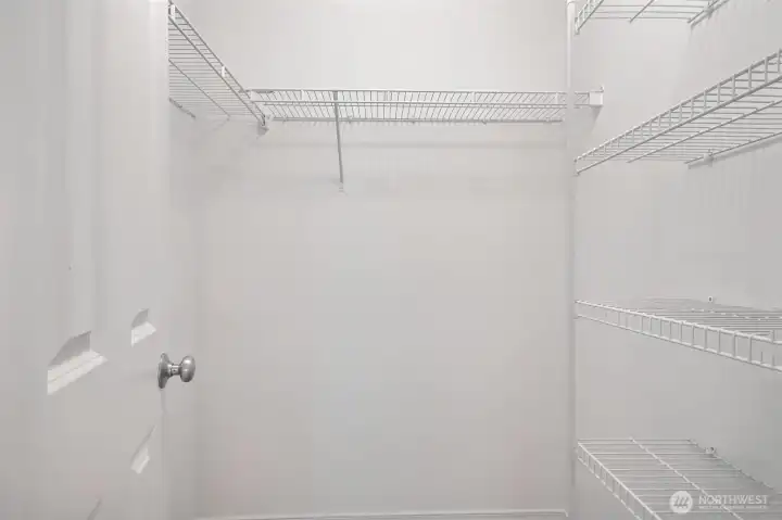 Walk in closet with custom shelves.