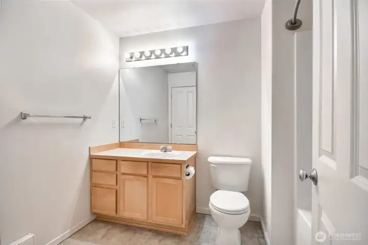 Lager oversized full bathroom with access to hallway and  primary bedroom.