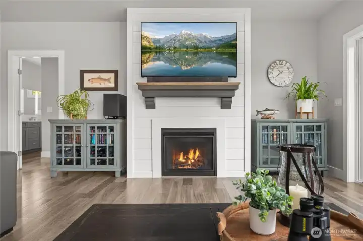 Cozy up on a cool day in the great room. The primary suite entrance is to the left of the fireplace.