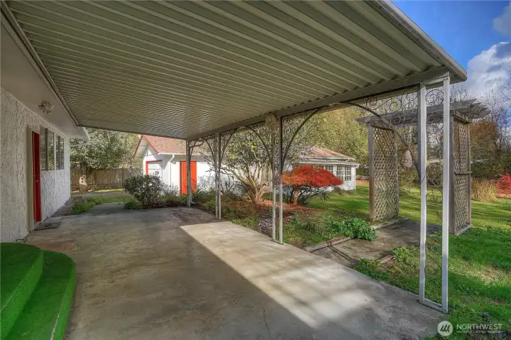 The covered patio is a great spot of yearround outdoor living. Detached garage beyond.