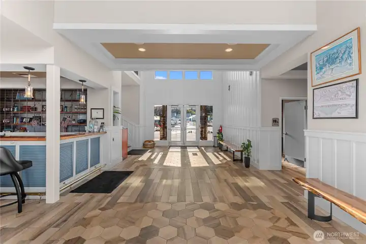 Lounge to the left (past the wet bar), restrooms, kitchen & elevator to the right.