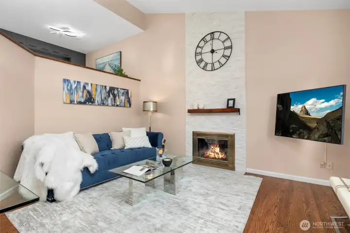 Sunken living room with floor to ceiling decorative fireplace wall