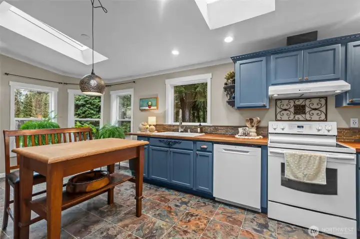 This kitchen wows! It's so tastefully updated. Big windows and skylights really warm the space and give it the homey, inviting feel (table island does not convey)