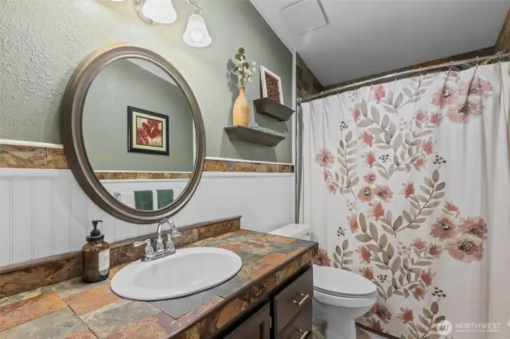 Main bathroom off hallway with slate tile accents