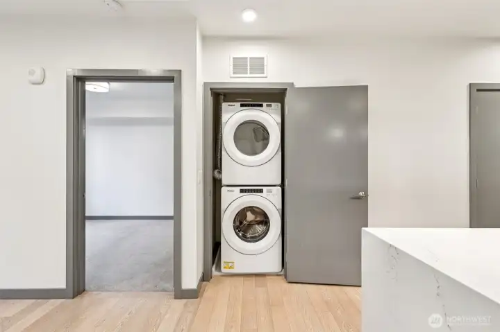 In-home laundry suite featuring full-capacity, high-efficiency washer and dryer