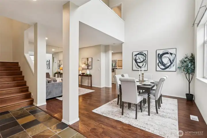 Soaring ceilings and an open, airy layout make this dining and living space feel both grand and inviting—perfect for everyday living and effortless entertaining.