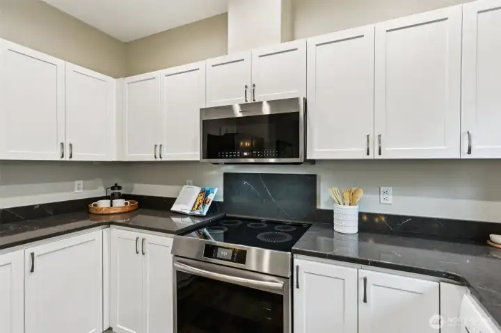 Clean and updated kitchen with white cabinetry and modern finishes