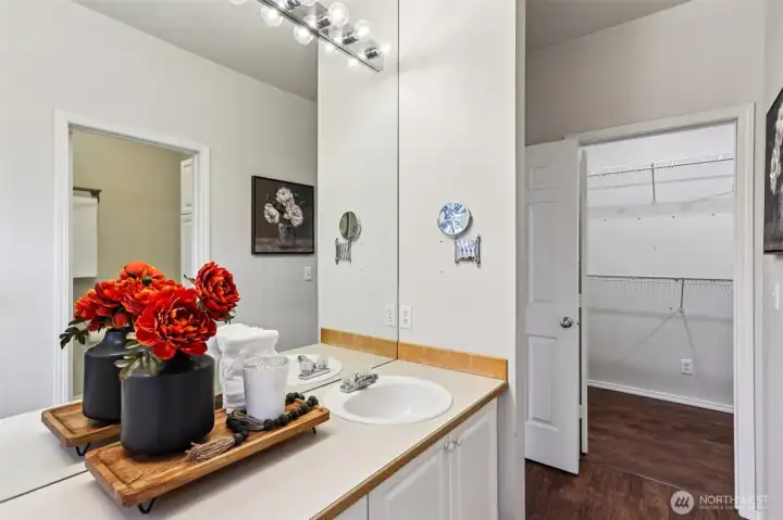 Primary bathroom with ample counter space and a walk-in closet just steps away for added convenience.