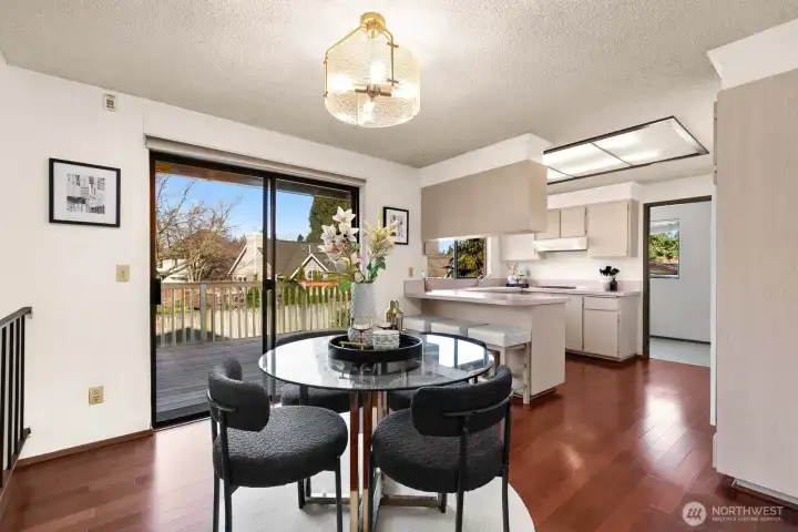 Dining and kitchen area + slider out to back deck and yard.