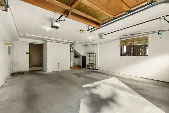 Large 2 car garage with great walk-in storage area - access door seen in right corner.