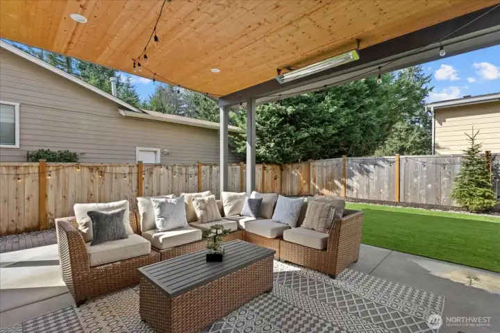 The covered patio extends the living experience outdoors, opening to a beautifully maintained backyard with premium turf for effortless entertaining and low-maintenance luxury.