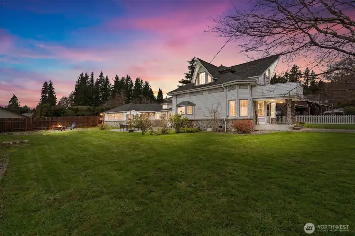 Expansive backyard retreat with lush green space—perfect for entertaining, gardening, or enjoying peaceful Pacific Northwest evenings.