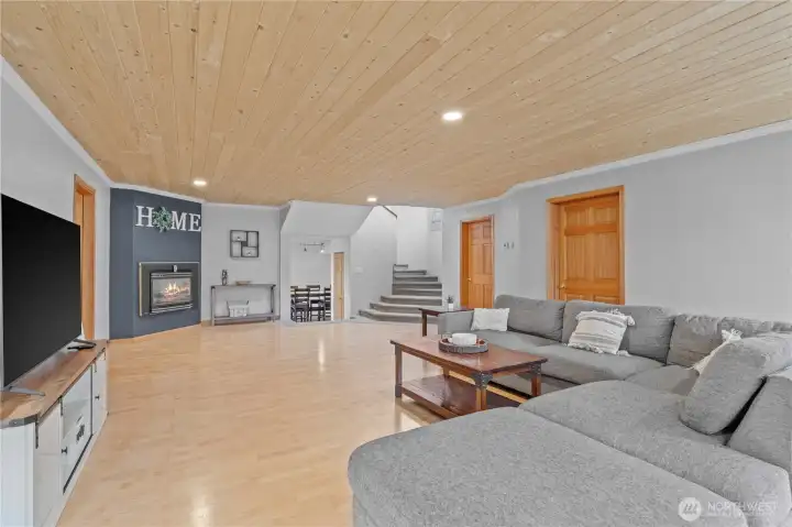 Bright and open living space with natural light, cozy gas fireplace, and warm finishes—ideal for relaxing or hosting guests in this Montesano farmhouse.