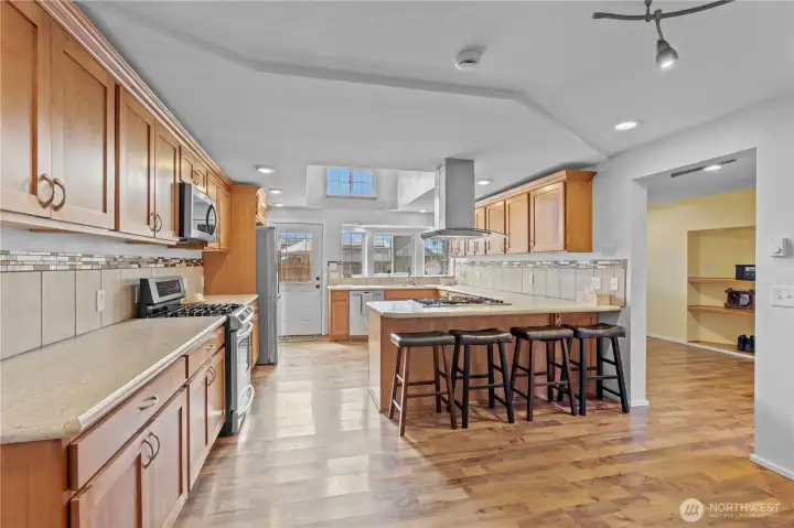 Large farmhouse kitchen with extensive cabinetry, ample counter space, and open design—ideal for cooking, hosting, and daily functionality.