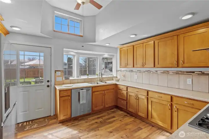Spacious kitchen with wraparound cabinetry and efficient workflow—ideal for both everyday living and hosting guests.
