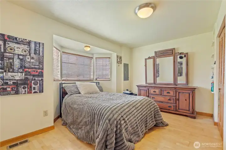 Comfortable bedroom with natural light and peaceful setting—ideal for rest and relaxation.