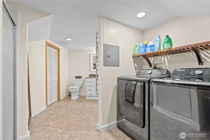 Dedicated laundry room with shelving and storage—designed for convenience and efficiency.